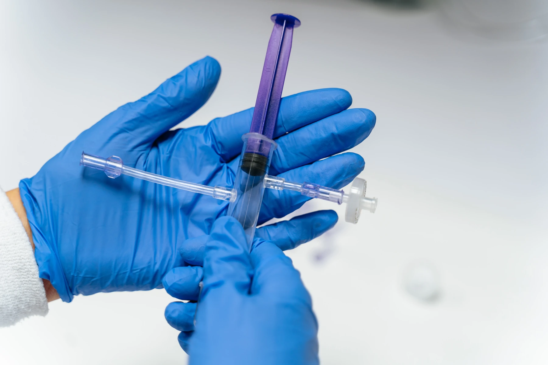 Photograph of the CryoKeep prototype held in blue-gloved hands